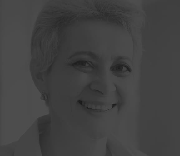 Mature woman sitting at her desk on the computer